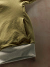 Close-up of a green and gray garment on a dark background