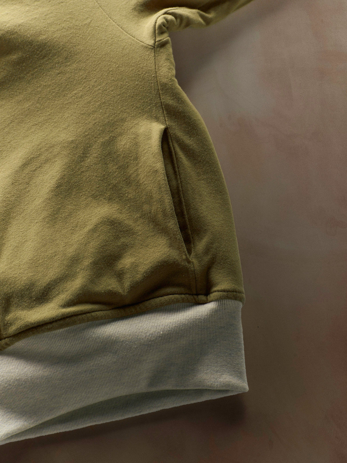 Close-up of a green and gray garment on a dark background