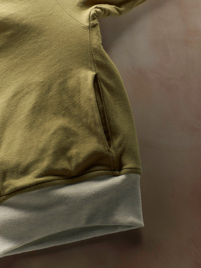 Close-up of a green and gray garment on a dark background