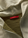 Close-up of a jacket with a red label on a neutral background