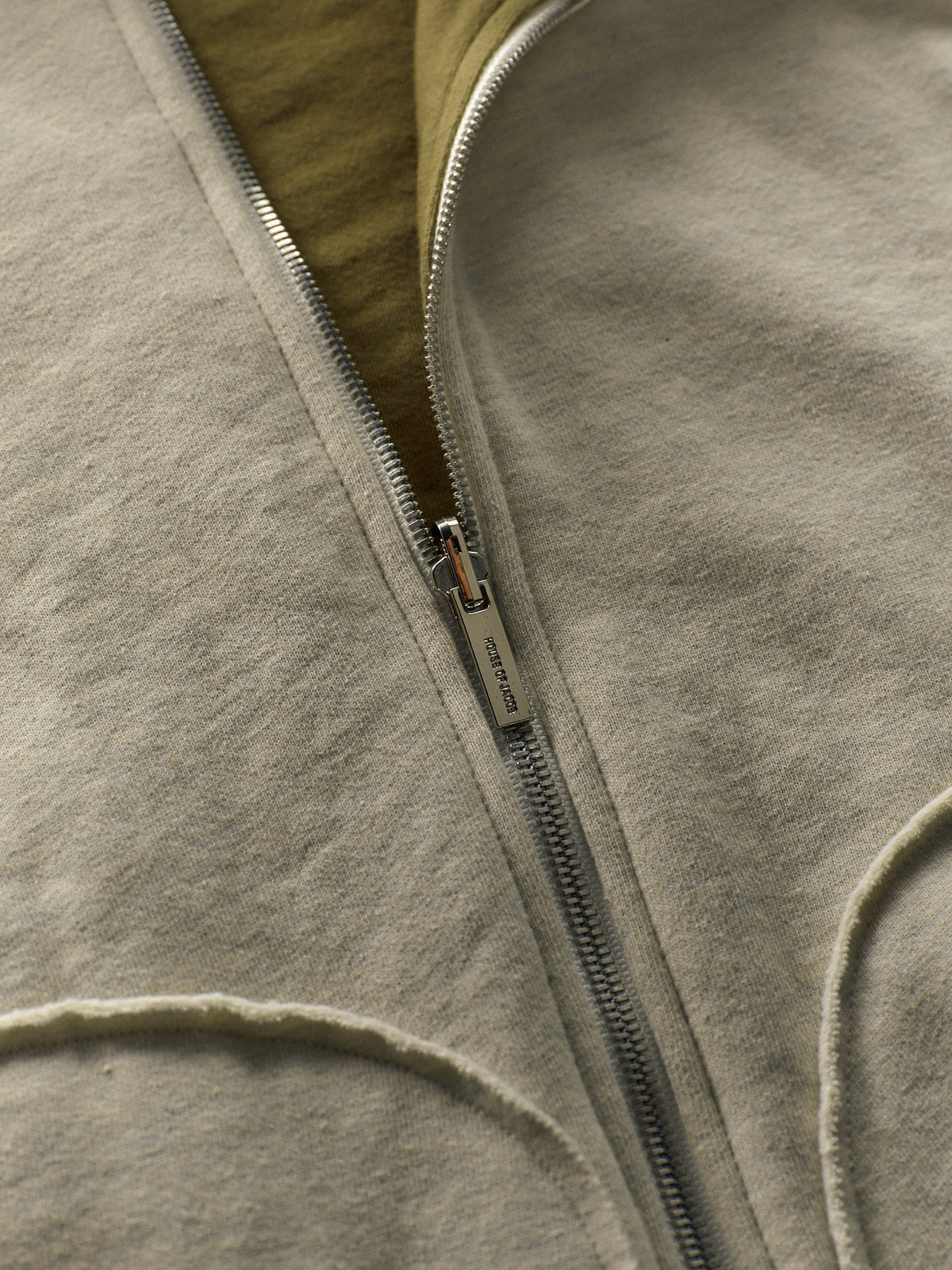 Close-up of a zipper on a beige fleece jacket